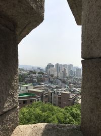 Buildings in city against clear sky