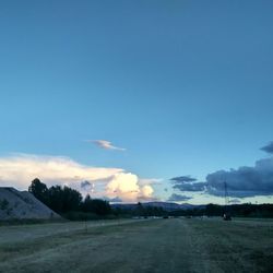 Scenic view of field against blue sky