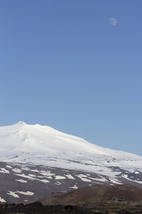 Scenic view of snowcapped mountains against clear blue sky