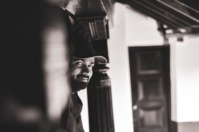 Portrait of young man standing at home