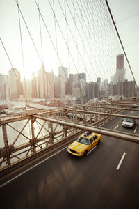 High angle view of car and yellow taxi on brooklyn bridge