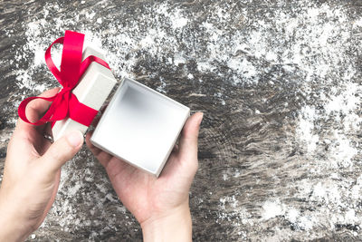 Cropped image of person holding box over table