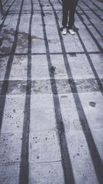 Low section of person standing on footpath