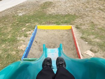 Low section of child sliding in playground