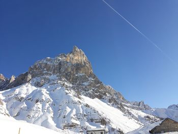 Scenic view of snowcapped mountains against clear blue sky