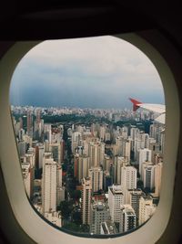 Aerial view of city seen through airplane window