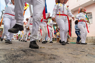 Low view of the legs of marujada de curaca members dancing at the chegancas cultural meeting