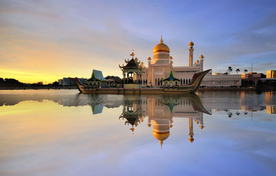 Reflection of temple in river during sunset