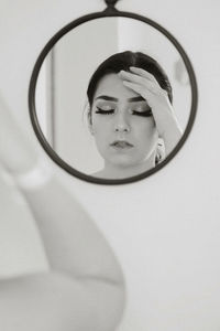 Young woman reflecting on mirror