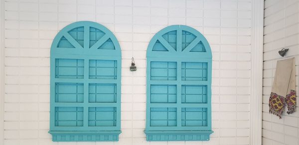 Blue window on white wall of building