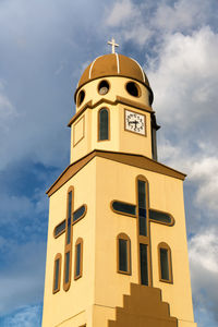 Low angle view of bell tower against sky