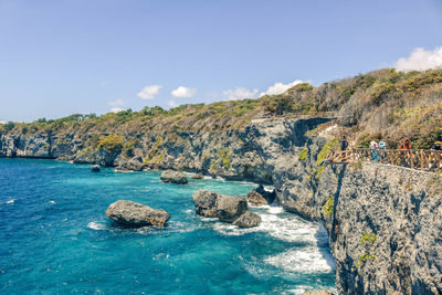 Scenic view of sea and mountains against sky