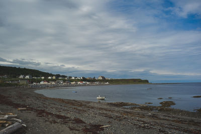 View of beach against cloudy sky