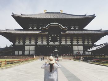 Rear view of boy on temple against building