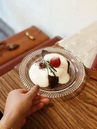 Midsection of woman holding ice cream in plate