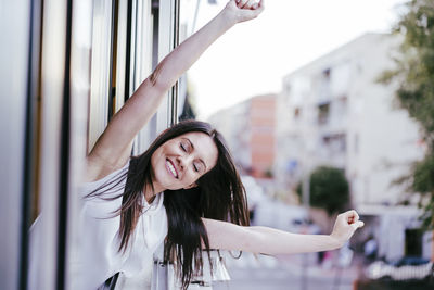 Portrait of smiling young woman standing outdoors