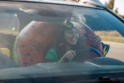 Portrait of young woman in car