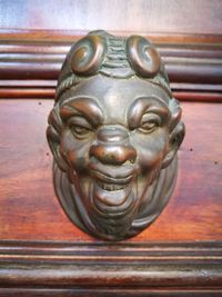 Close-up of buddha statue on wood