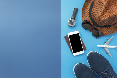 Directly above shot of traveling objects on blue background