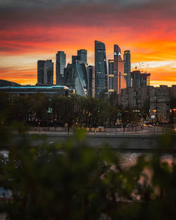 Buildings in city during sunset