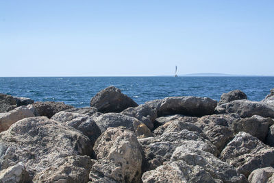 Scenic view of sea against clear blue sky