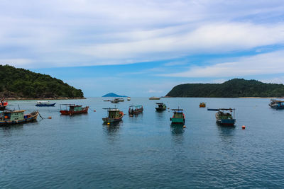 Boats moored on sea against sky