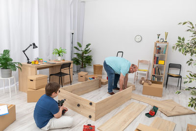 Rear view of man working at home