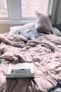 High angle view of laptop on bed at home