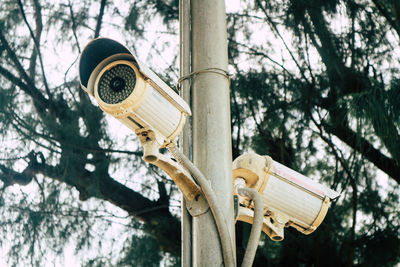 Low angle view of street light against trees