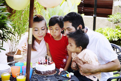 Family celebrating birthday in lawn