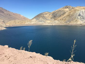 Scenic view of sea and mountains against sky