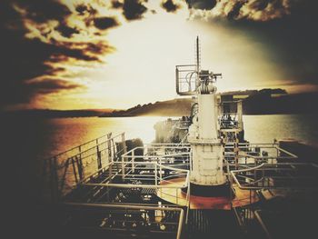 Ship in sea against sky during sunset