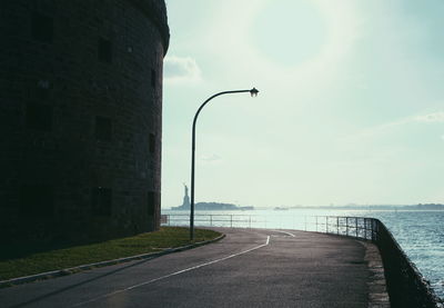 Empty road along buildings