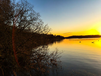 Scenic view of lake at sunset