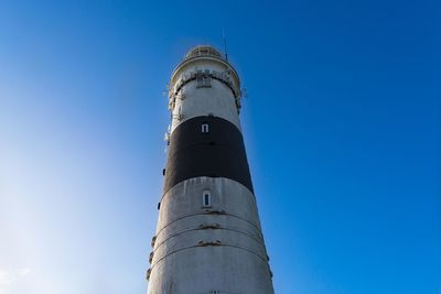 Low angle view of lighthouse against clear blue sky