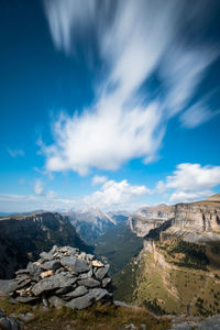 Scenic view of mountains against blue sky