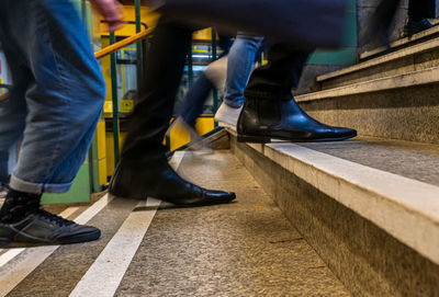 Low section of people walking on staircase