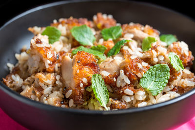 Close-up of rice with fried chicken in container