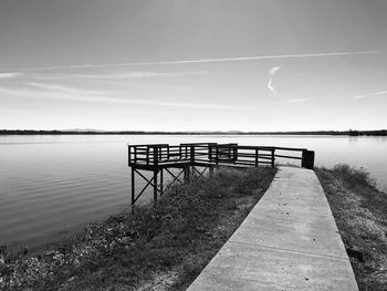 Pier over lake against sky