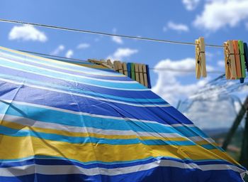 Low angle view of flags hanging against sky