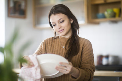 Young woman baking cookies in the kitchen