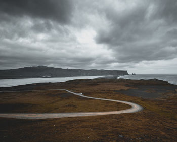 Scenic view of road by land against sky