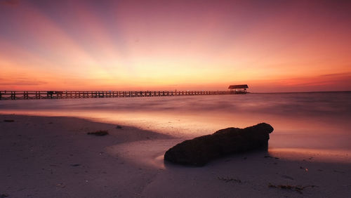 Scenic view of beach against sky during sunset