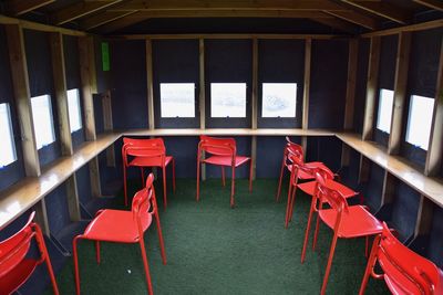 Empty chairs and tables in restaurant