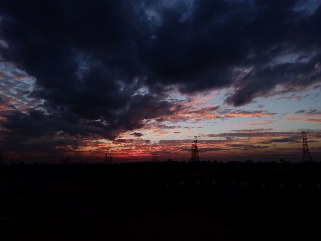 SILHOUETTE OF CITY AGAINST DRAMATIC SKY