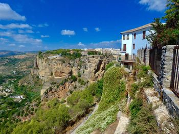 Panoramic view of trees and buildings against sky