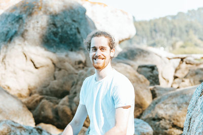 Portrait of man standing on rock