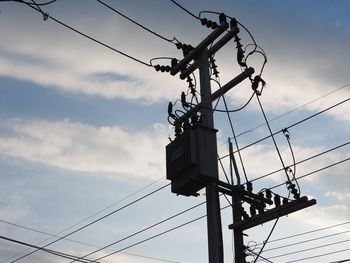 Low angle view of electricity pylon against sky