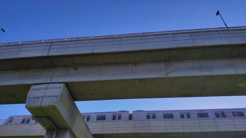 Low angle view of bridge against buildings