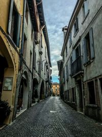 Street amidst buildings against sky